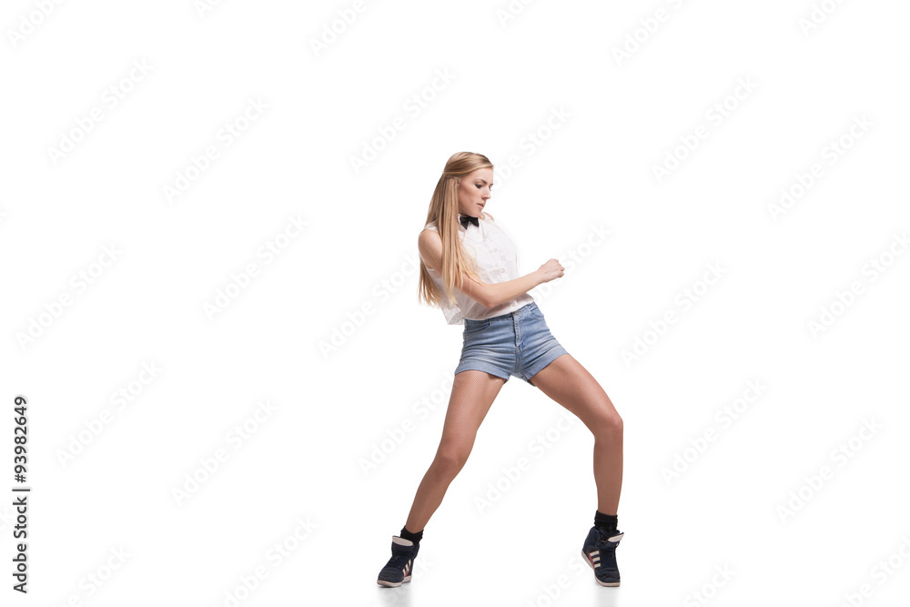 Young beautiful dancer posing on studio background