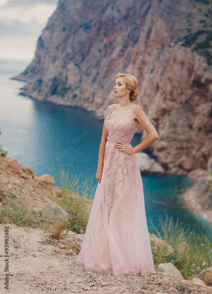 Beautiful bride in a wedding dress on a background of the sea Beautiful bride in a wedding dress on a background of the sea