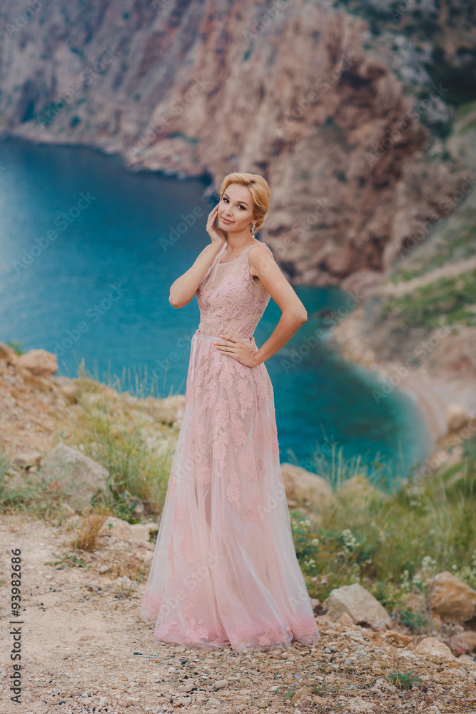 Beautiful bride in a wedding dress on a background of the sea