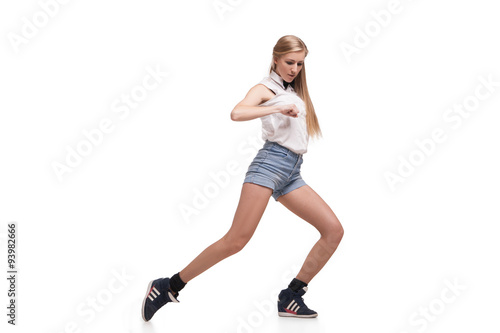 Young beautiful dancer posing on studio background