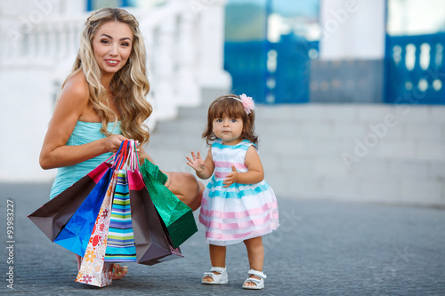 Woman during the shopping with the little girl