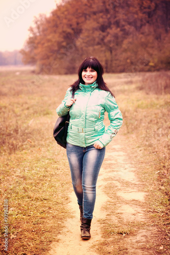  woman walking in autumn park