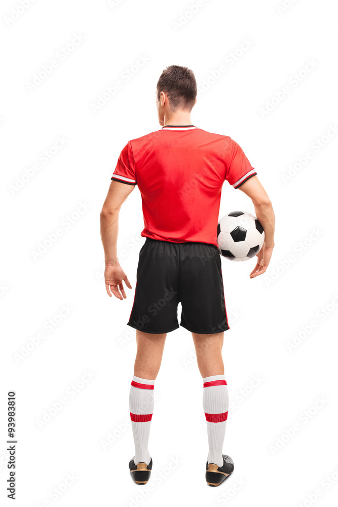 Football player in red jersey holding a ball Football player in red jersey holding a ball