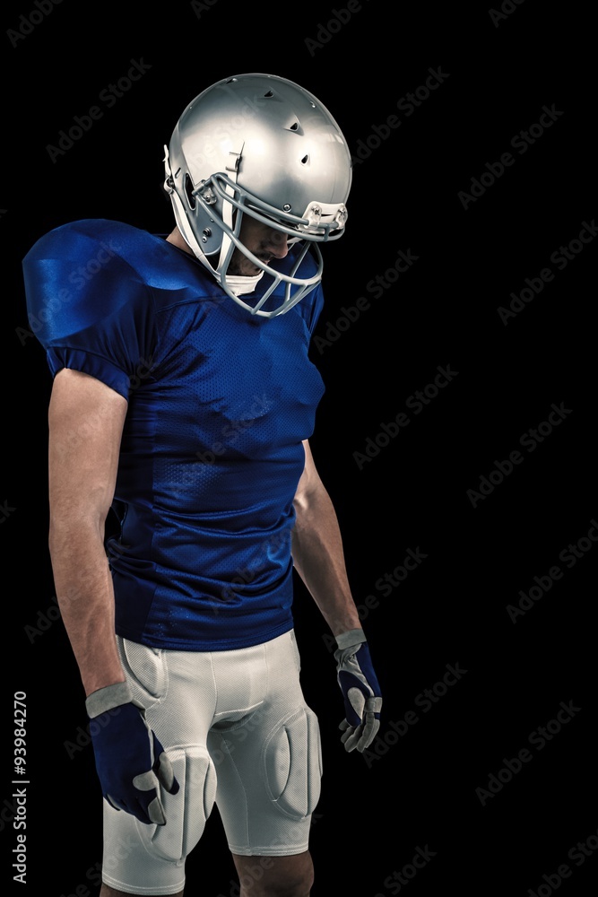Composite image of american football player looking down Composite image of american football player looking down