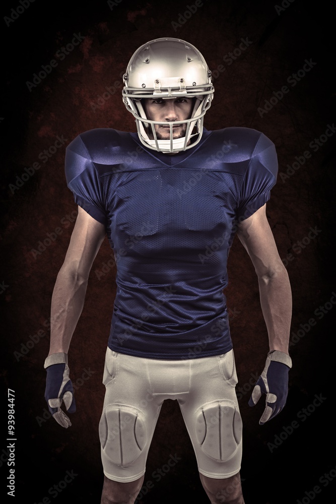 Composite image of serious american football player standing