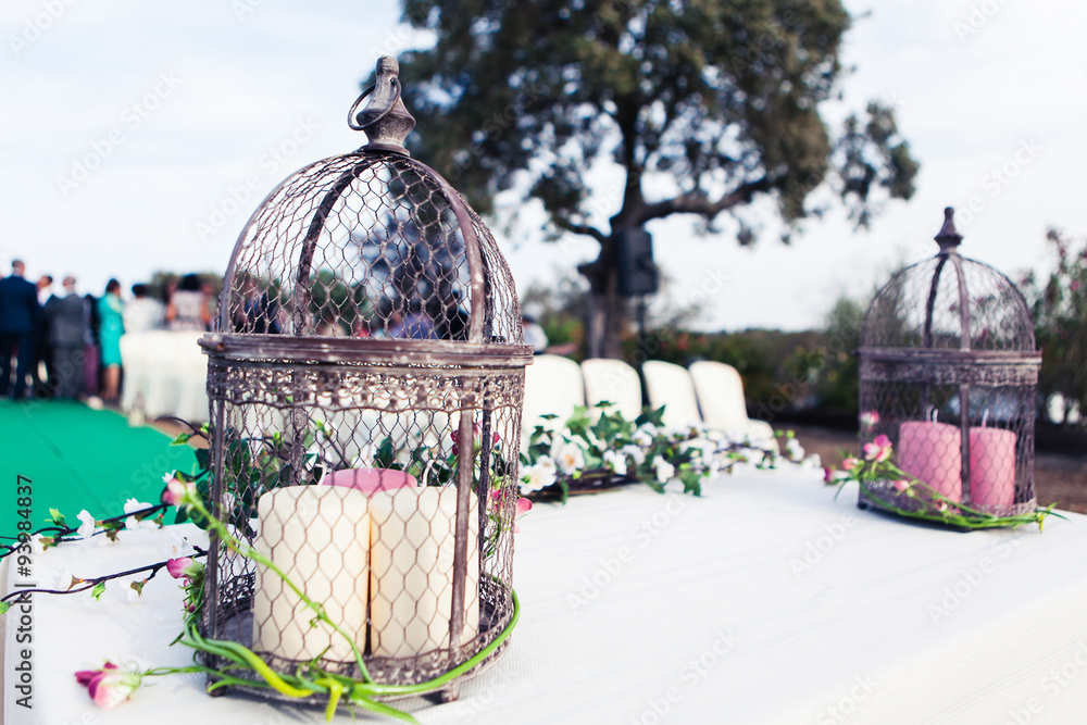 Vintage wedding altar with birdcage, candles and plants. Close up.