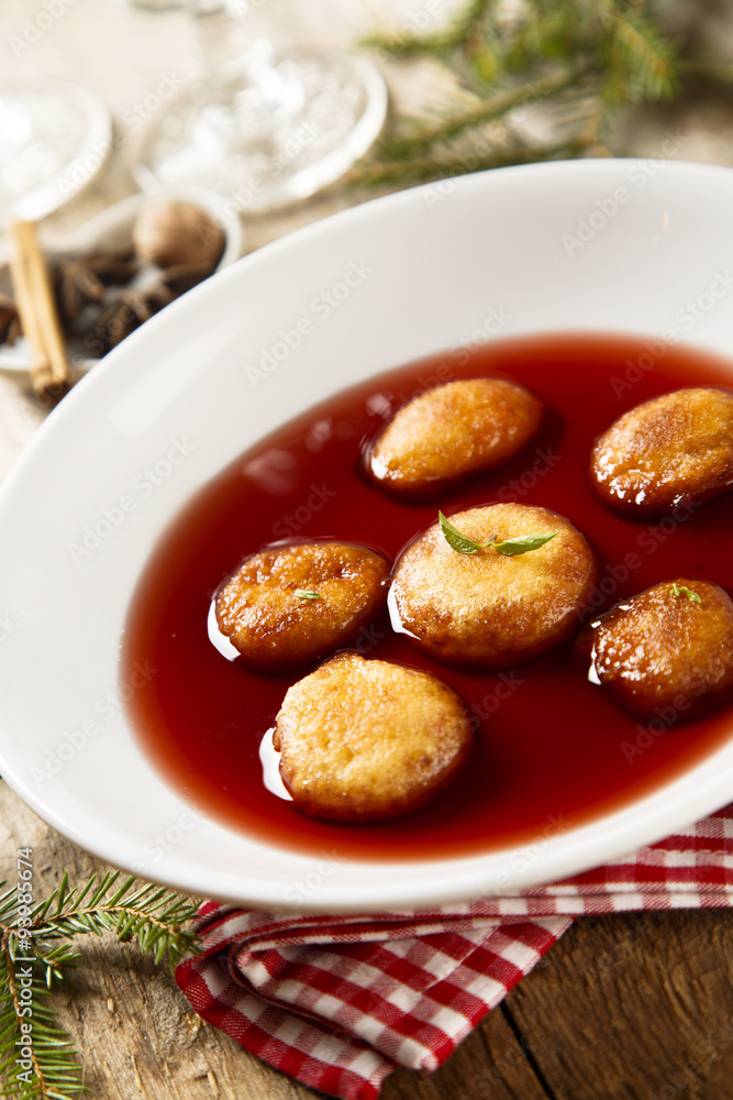 Sweet fried donuts in wine sauce
