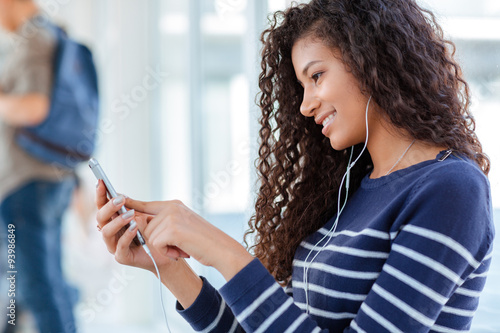 Woman using smartphone with headphones