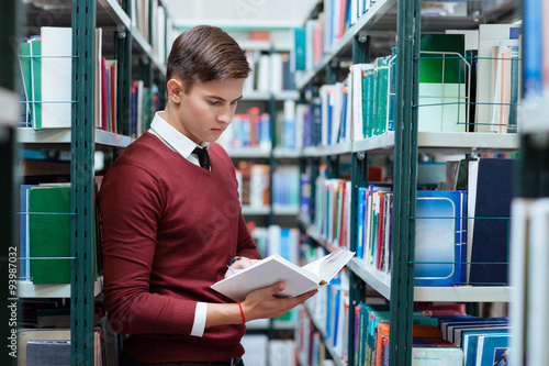 Student searching book in university library