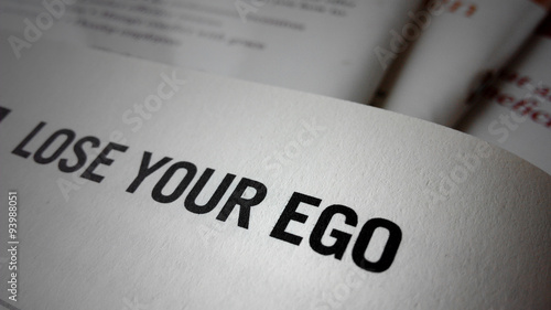 Fotografie Lose your ego word on a book
