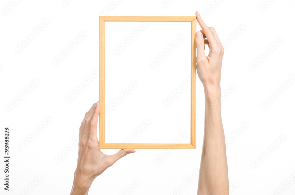 House decoration and Photo Frame topic: human hand holding a wooden picture frame isolated on a white background in studio House decoration and Photo Frame topic: human hand holding a wooden picture frame isolated on a white background in studio