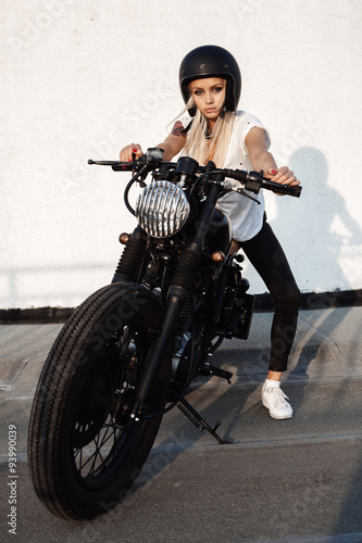 fashion female biker girl with vintage custom motorcycle