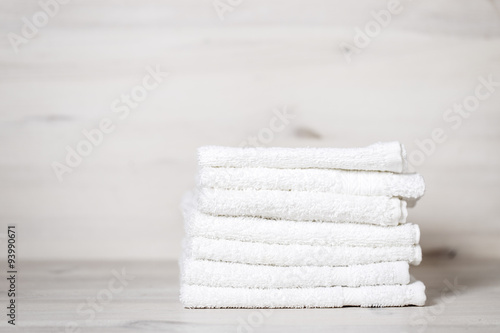 stack of spa towels on white wooden table