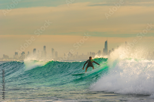 Surfer Surfing a wave with Surfers Paradise in the Background