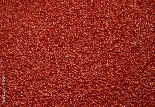 Dark red rough, porous,surface.Horizontal.
