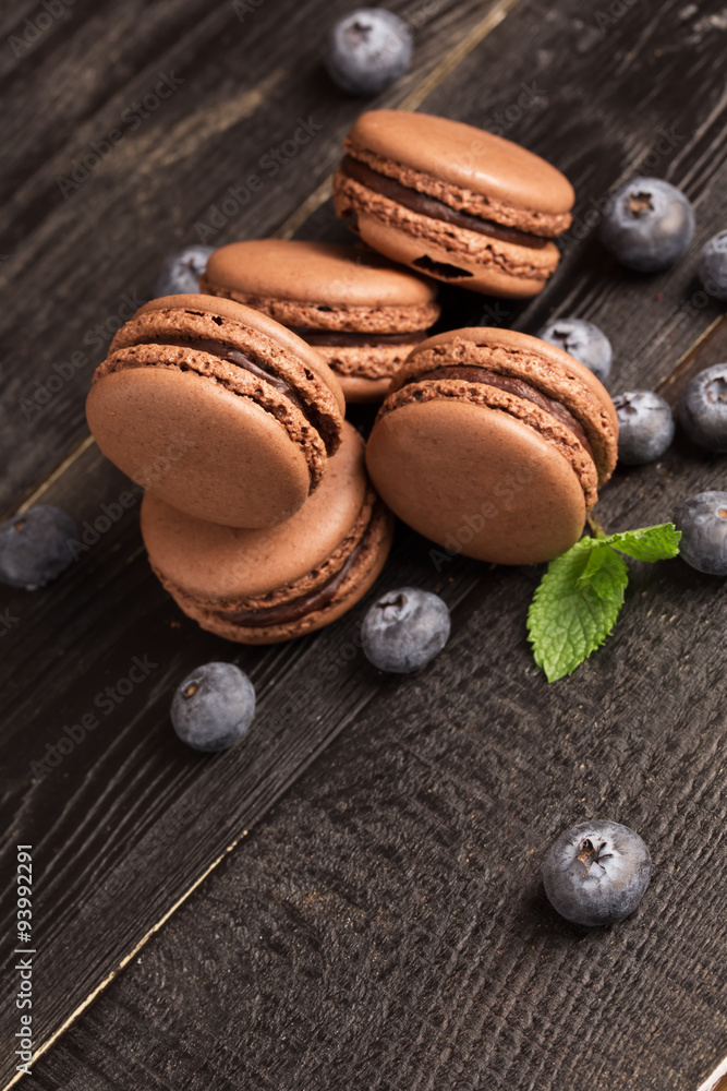 Pile of chocolate macaroons and blueberry Pile of chocolate macaroons and blueberry