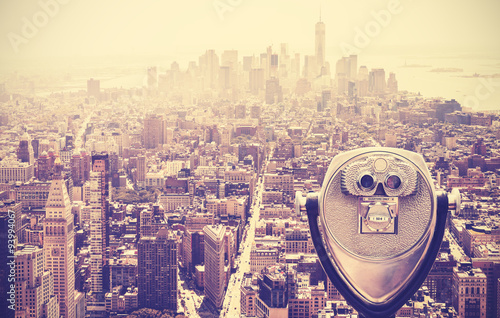 Retro vintage toned tourist binoculars over Manhattan, NYC, USA.