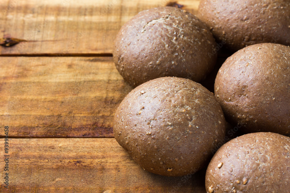 Rye bread on wooden background.