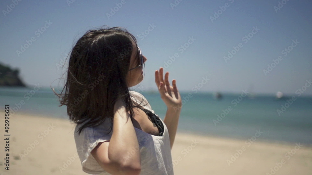 Young, happy woman playing with hair on beach, slow motion 240fps
Young, happy woman playing with hair on beach, slow motion 240fps