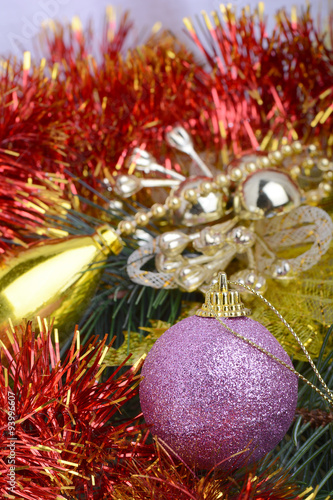 Closeup of Christmas balls and green fir tree branch, new year invitation card