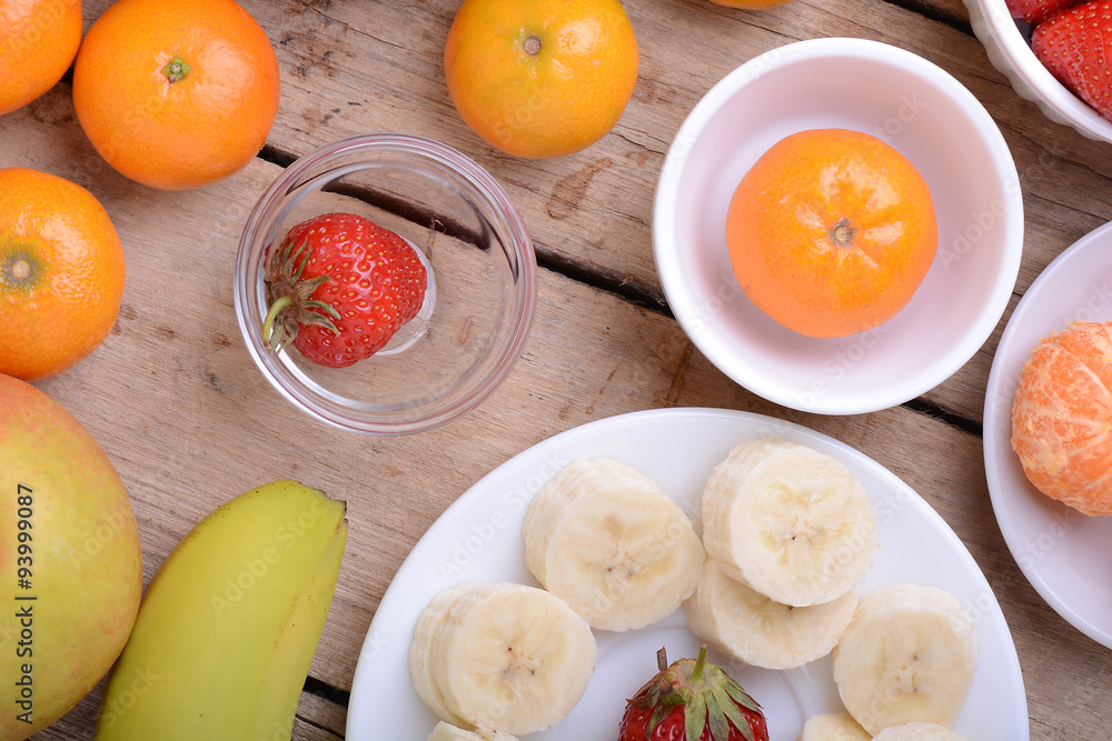 Fresh colorful fruits composition mandarin, strawberry, peach, bananas and orange