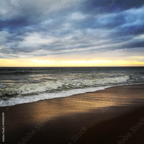 Fototapeta Naklejka Na Ścianę i Meble -  heavy cloud cant hide sunset over the Atlantic coast