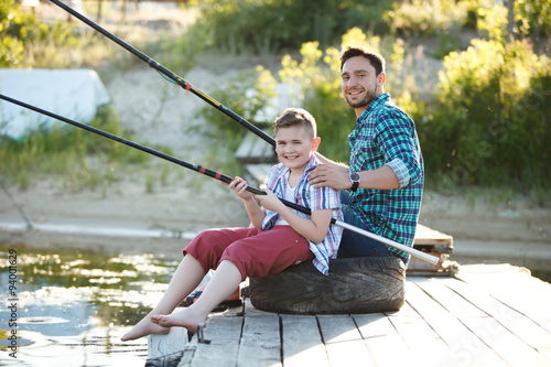 Man and boy fishing on the lake