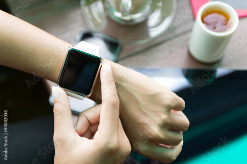 hand using watch on top view