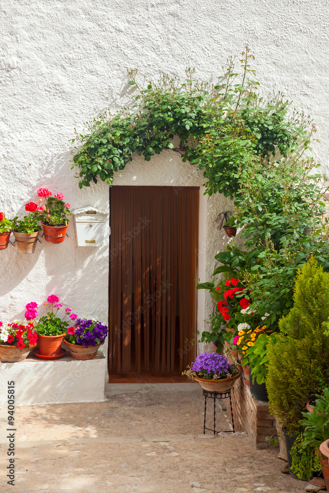 Traditional mediterranean house door decorated flowers and