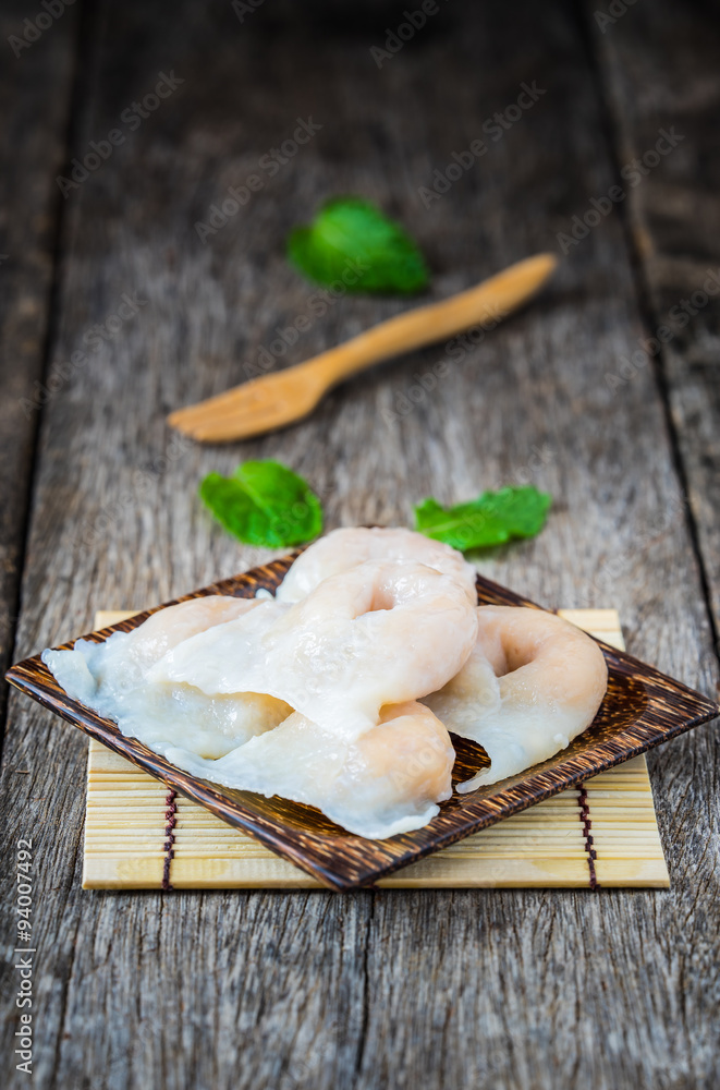 Fish dumplings in wooden dish on old wood background.