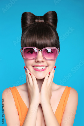 Happy smiling teen girl with bow hairstyle, funny model wearing