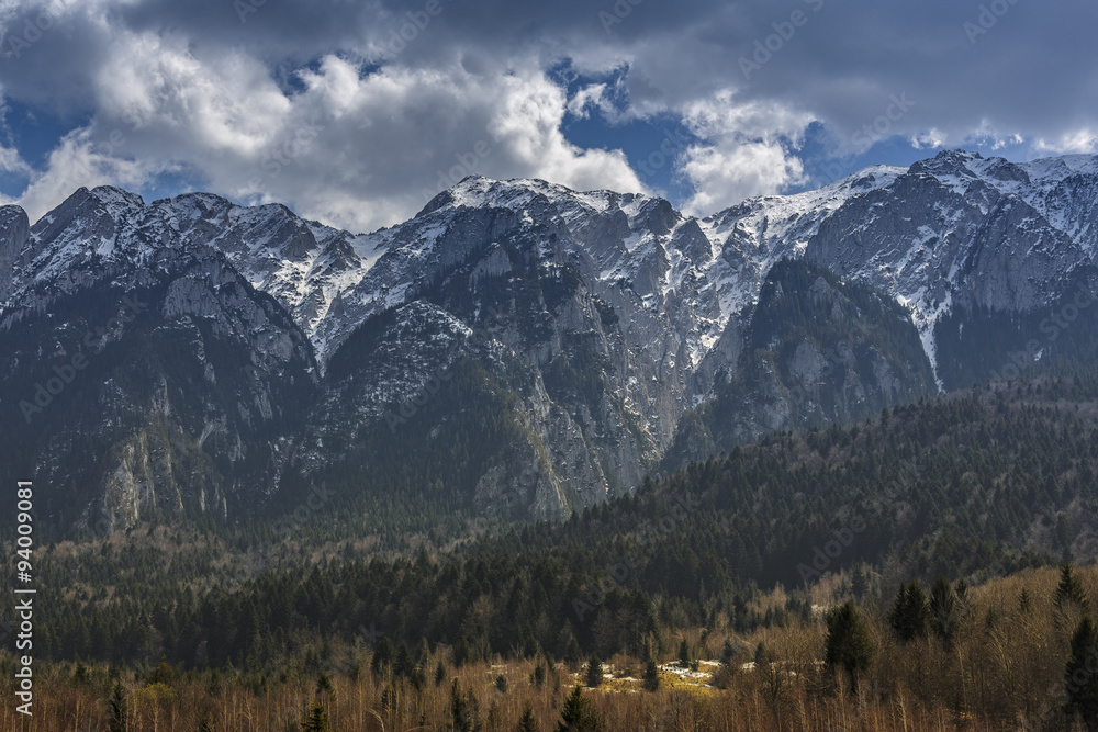 Peaceful alpine landscape with snowy mountains range in the Bucegi National Park, Romania. Travel destinations, touristic attractions.