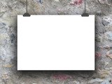 Single horizontal hanged paper sheet with clips on rough concrete wall background