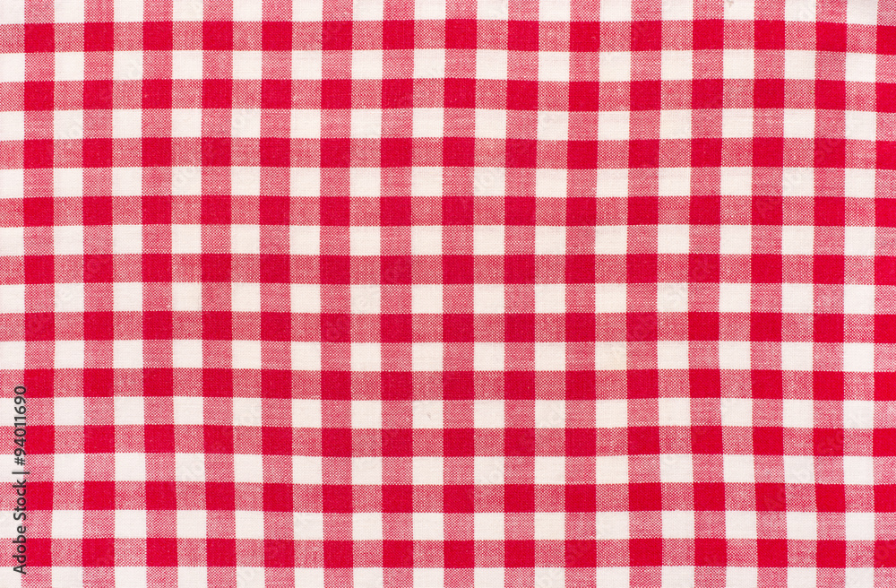 Close up on checkered tablecloth fabric. Red with white tartan square pattern as background. Close up on checkered tablecloth fabric. Red with white tartan square pattern as background.
