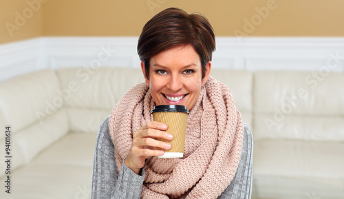 Mature woman with scarf and coffee mug.