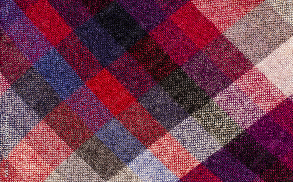 Scottish tartan pattern. Red plaid print as background. Colored lines and square pattern. Scottish checked fabric. Scottish tartan pattern. Red plaid print as background. Colored lines and square pattern. Scottish checked fabric.