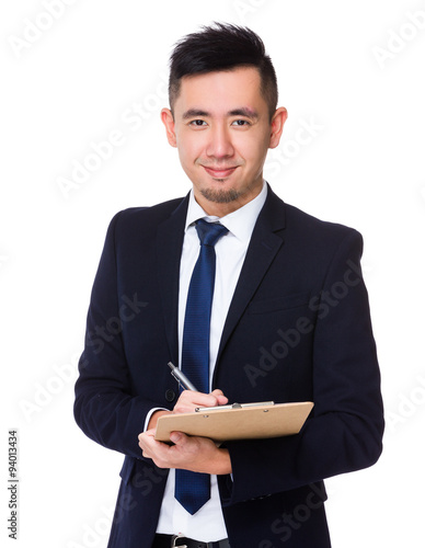 Asian businessman take note on clipboard