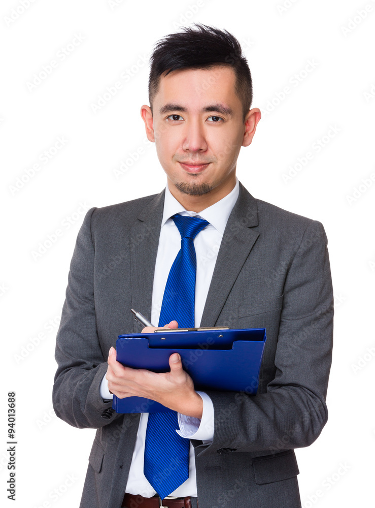 Asian Young Businessman take note on clipboard Asian Young Businessman take note on clipboard