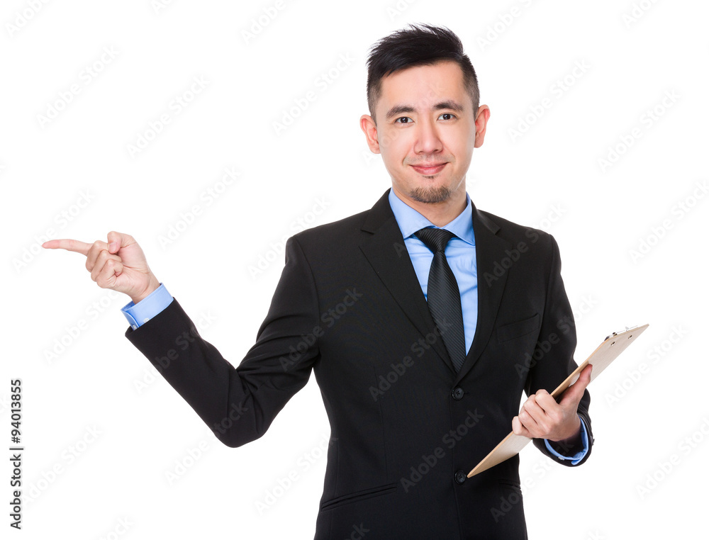 Asian Businessman hold with clipboard and finger point aside Asian Businessman hold with clipboard and finger point aside