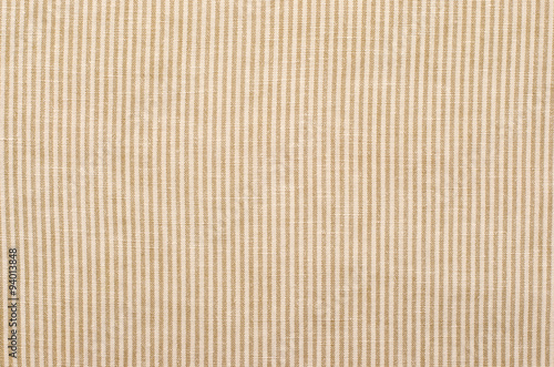 Striped brown and beige textile pattern as a background. Close up on diagonal stripes material texture fabric.