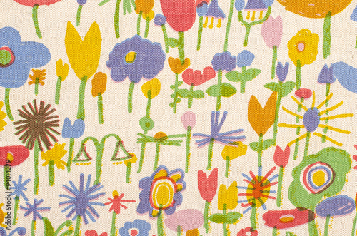 Abstract floral pattern on fabric. Colorful childish flowers print as background. Flowers painted by a child.