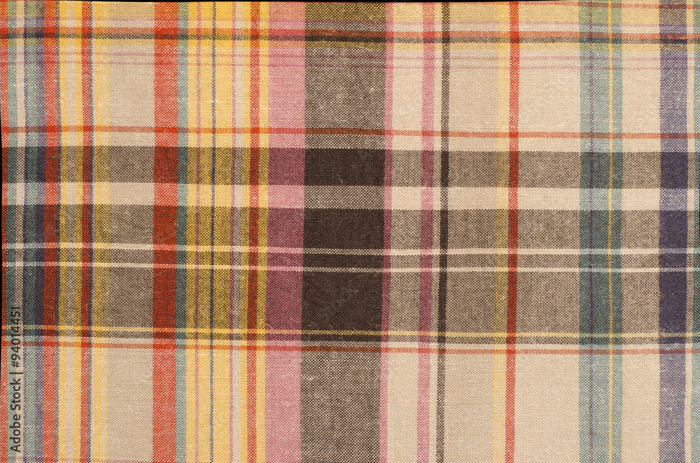 Scottish tartan pattern. Orange and green with yellow plaid print as background. Colored lines and square pattern. Scottish checked fabric. Scottish tartan pattern. Orange and green with yellow plaid print as background. Colored lines and square pattern. Scottish checked fabric.