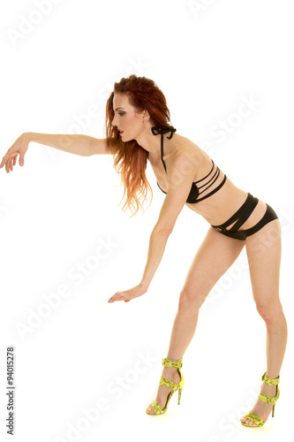 woman with red hair black bikini bend over hands out