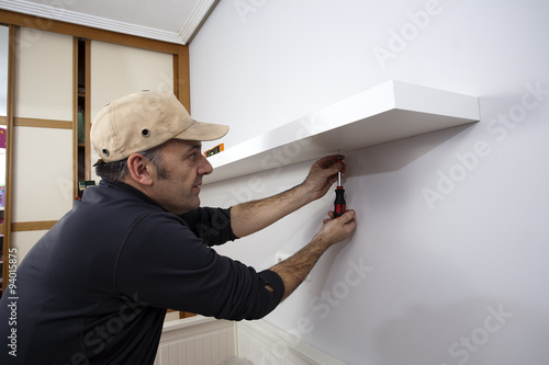 Carpenter placing a shelf