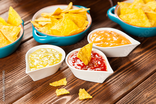 Plate of nachos with different dips