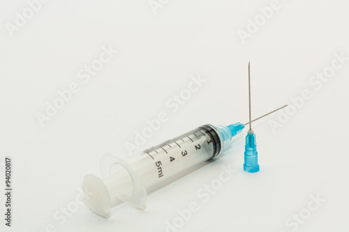 One disposable plastic 5ml syringe and blue needle photo