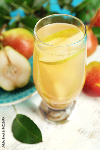 Fresh pear juice with fruit on table close up
