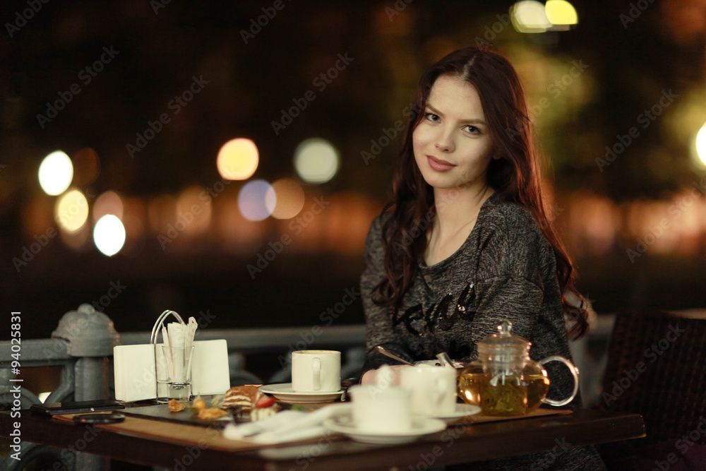 girl, night, dinner at an outdoor cafe