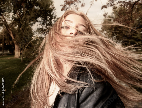 Принти на полотні Young woman with hair swept by wind