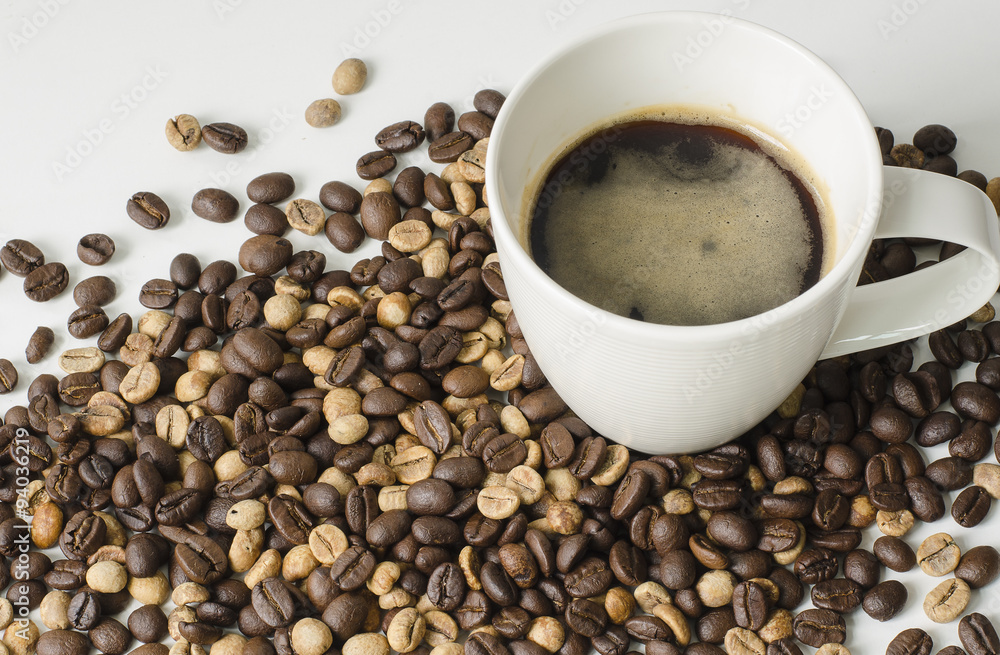 Coffee in cup and coffee beans on white background Coffee in cup and coffee beans on white background